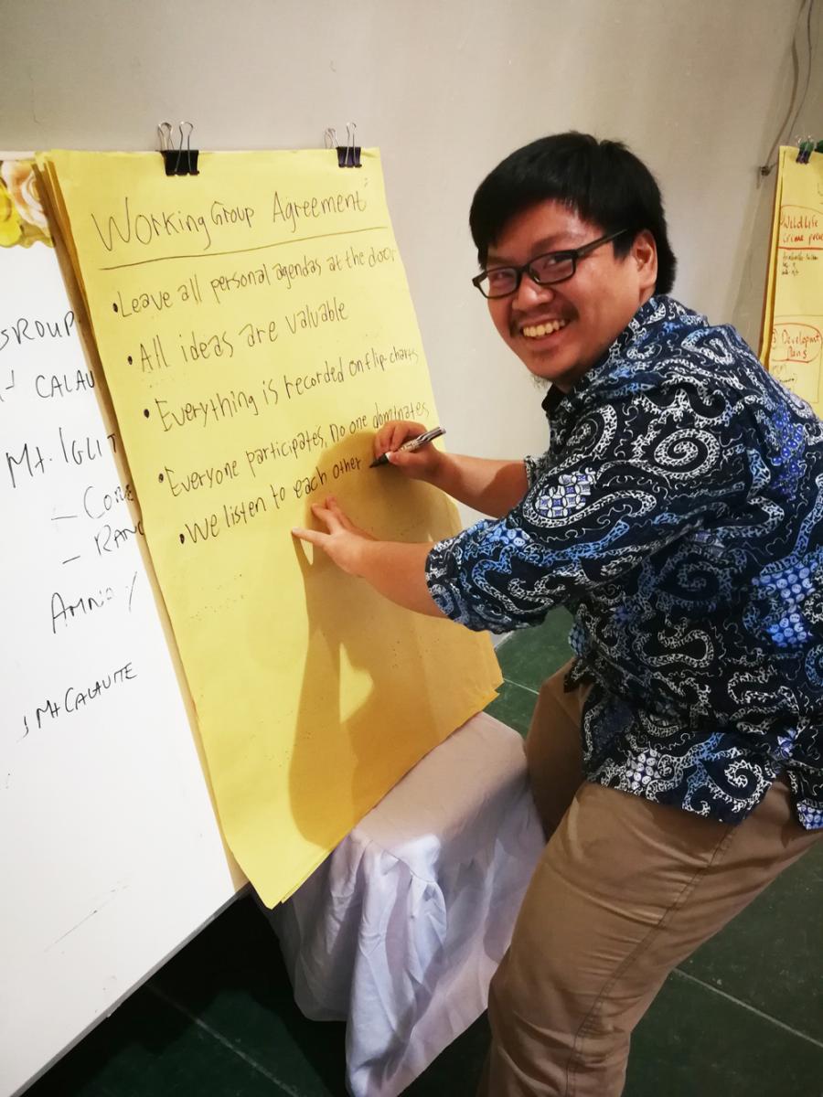 Yonathan writes on a large paper pad